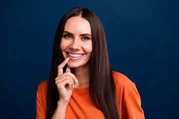 Photo of nice woman with straight hairdo dressed orange t-shirt finger on teeth advertise dental...