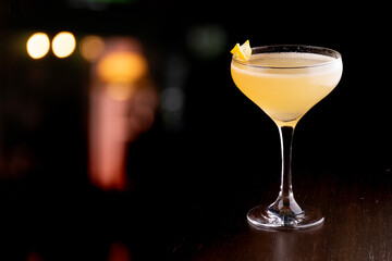 refreshing cocktail glass of shaken vodka with lime blurred pub background - obrazy, fototapety, plakaty