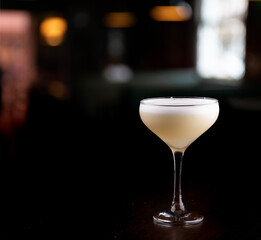 pisco sour cocktail glass with blurred background