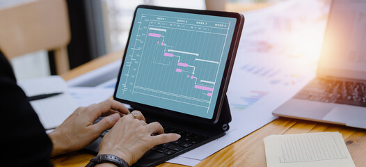 Business hands working on digital tablet with business infographic data concept, Analytics data dashboard.