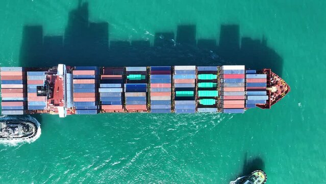 Aerial view of Cargo Container Ship at sunrise. container ship running out of cargo shipyard sea port. export shipping industry freight and transportation logistics concept. commercial shipping by sea