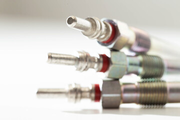 Modern ceramic glow plugs for warming up a diesel engine before starting. White background, isolate. Macro