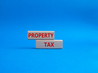 Property Tax symbol. Concept word Property Tax on wooden blocks. Beautiful blue background. Business and Property Tax concept. Copy space
