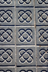Sidewalk with panot (tiles with flower inside) in Barcelona, Catalonia, Spain, Europe