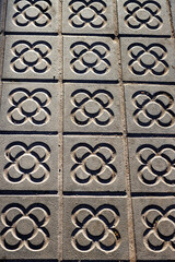 Sidewalk with panot (tiles with flower inside) in Barcelona, Catalonia, Spain, Europe