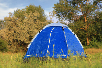 tourist tent on medow - 719145469