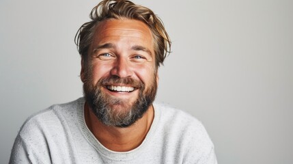 Portrait of man smiling on white background.