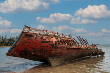 shipwreck on beach with blue sky background, abandoned boat on beach at phuket, thailand.