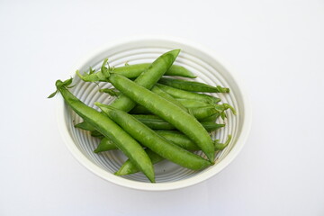 Fresh green pea isolated on white background. There is a lot of vitamins  and Minerals in it. The pea is most commonly the small spherical seed or the seed. Popular vegetable of all over world. 