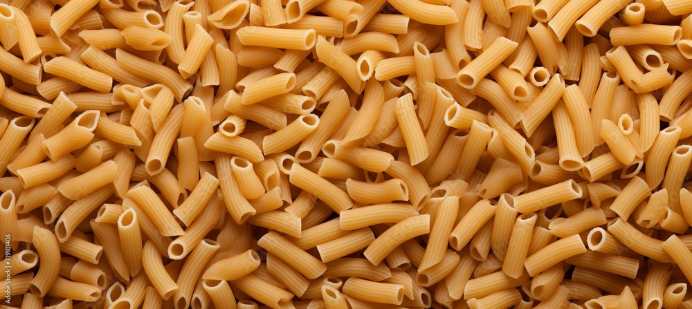 Poster vibrant top view of italian pennettine pasta as abstract background with textured patterns