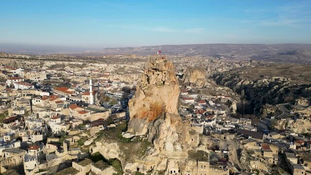 Aerial drone view of the Ortahisar Castle in Cappadocia, Turkey. People enjoying the view from the top of the castle.