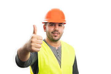 Cheerful male builder smiling making thumb-up like gesture