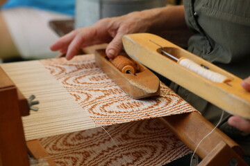 Person Weaving a Tapestry on a Loom
