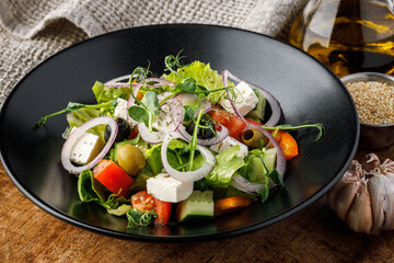 Greek salad with feta cheese, olives, tomatoes and herbs