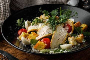 Chicken salad with croutons, cherry tomatoes and arugula