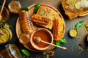 A wooden plate with honeycombs filled with honey. Fresh organic honey.