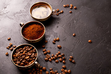 Coffee background - cup of black coffee, coffee beans and ground coffee on a black background, copy space for text