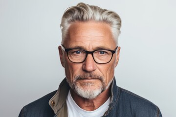 Portrait of a handsome senior man with grey hair wearing glasses