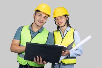 Asian Couple Engineer & Architect gives gestures and expressions on construction field with laptop