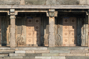 Wooden doors and ornate stone carvings at the ancient Chennakeshava temple in Belur, Karnataka.