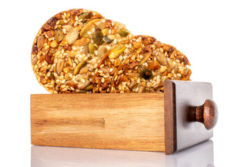 Several sweet Italian cookies with nuts in a wooden box, macro, isolated on white background.