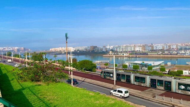 4K video of Modern tram passing by the Bou Regreg river and Scenic view of old city of oudaya with a view over the Grand Theatre of the capital city of Morocco, RABAT