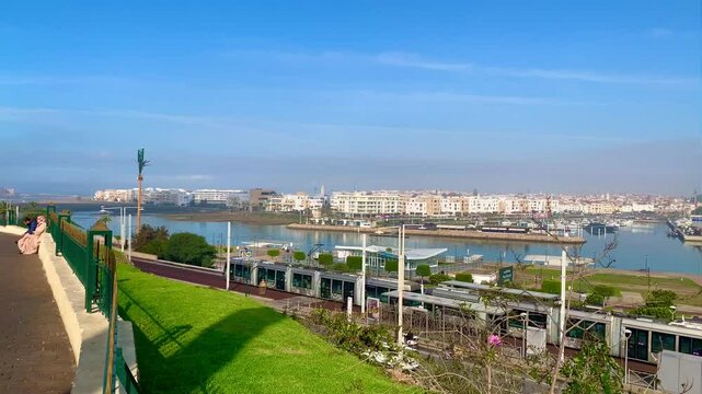 4K video of Modern tram passing by the Bou Regreg river and Scenic view of old city of oudaya with a view over the Grand Theatre of the capital city of Morocco, RABAT