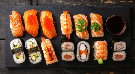 Selbstklebende Fototapeten Delicious sushi platter with various rolls on slate. © Jan