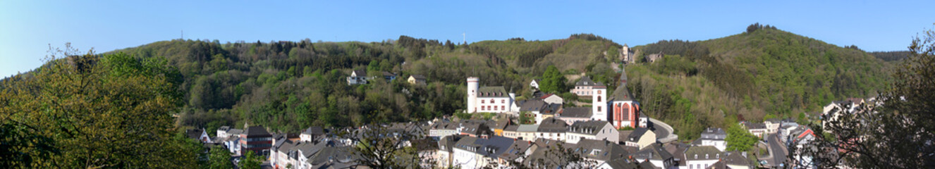 Fototapeta na wymiar Panoramic view of medieval Neuerburg city with its castle in the forest, Eifel region in Germany