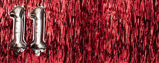 Silver foil balloon number eleven. Birthday greeting card with inscription 11. Anniversary concept. Numeral digit.