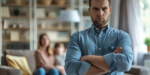 Anger abuse and domestic violence concept. Man threatening wife and kids with his fist. Scared mother and child sitting together on couch in scare. Selective Focus on male hand