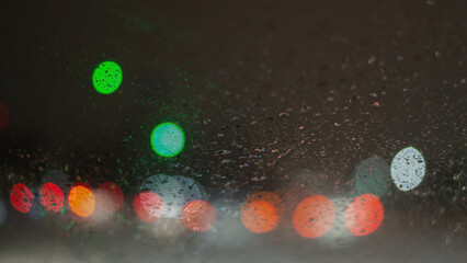 Blurred background with raindrops and lights.