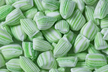 Close up top view of a pile of green and white striped mint candy