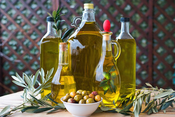 olive oil, extra virgin olive oil in a glass bottle, on a wooden table.
extra virgin olive oil, from organic olive groves in Greece, genuine taste of oil from the Mediterranean.

