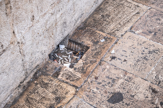 blocked water drain in the stone floor. clogged hole. It's filled with garbage.
