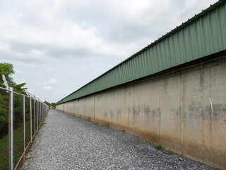 The barbed wire fence surrounds the water storage building.