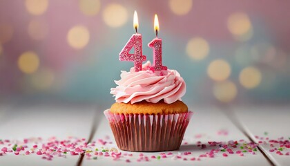 Birthday cupcake with burning lit candle with number 41. Number fortyone for fortyone years or fortyfirst anniversary. - obrazy, fototapety, plakaty