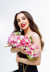 Beautiful young woman with bouquet of flowers