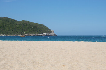 paradise beach located into colombian tayrona national park with tropical jungle and blue sky at background
