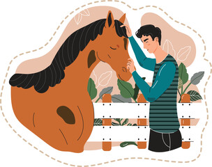 Young man bonding with horse, petting its forehead in a stable setting. Animal lover showing affection to a brown horse near white fence.