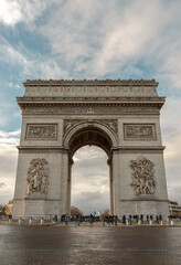 Fototapeta na wymiar Famous Arc de Triomphe (Triumphal Arch) at the city center of Paris and traffic trails in Chaps Elysees. Symbol of the glory and historical heritage, Iconic touristic architectural landmark, Tourism.