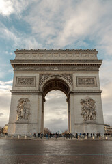 Obraz premium Famous Arc de Triomphe (Triumphal Arch) at the city center of Paris and traffic trails in Chaps Elysees. Symbol of the glory and historical heritage, Iconic touristic architectural landmark, Tourism.