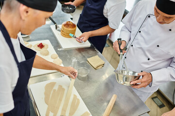 good looking multiracial chefs in aprons working with dough together on kitchen, confectionery