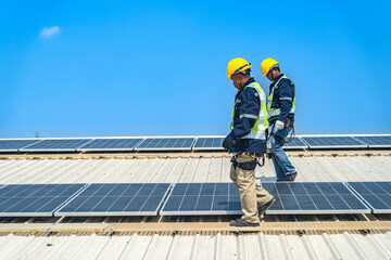 Fototapeta premium Worker Technicians are working to construct solar panels system on roof with sky and clound on background. Installing solar photovoltaic panel system. Renewable clean energy technology concept.