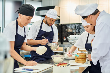 hard working multicultural chefs and chief cook working pasty together in kitchen, confectionery
