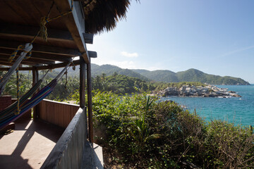 Landscape viewpoint of cabo san juan hut located in tayrona park with hammocks and caribbean sea