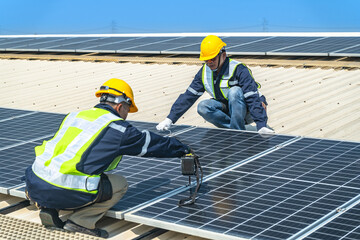 engineer men inspects construction of solar cell panel or photovoltaic cell at roof top. Industrial...