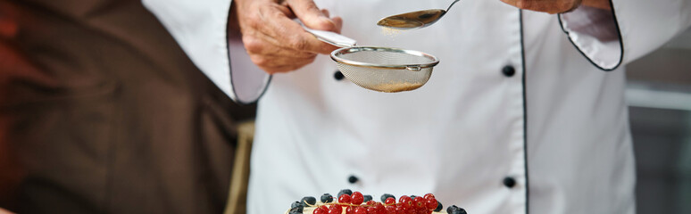 cropped view of mature male chef decorating his tasty cake professionally, cooking courses, banner