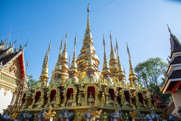 group of small golden pagoda in Wat Phra That Suthon Mongkhon Khiri, Phrae province, northern of Thailand.