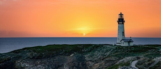 The Yaquina Head Lighthouse with a blue and pink sunset at Newport, Oregon.